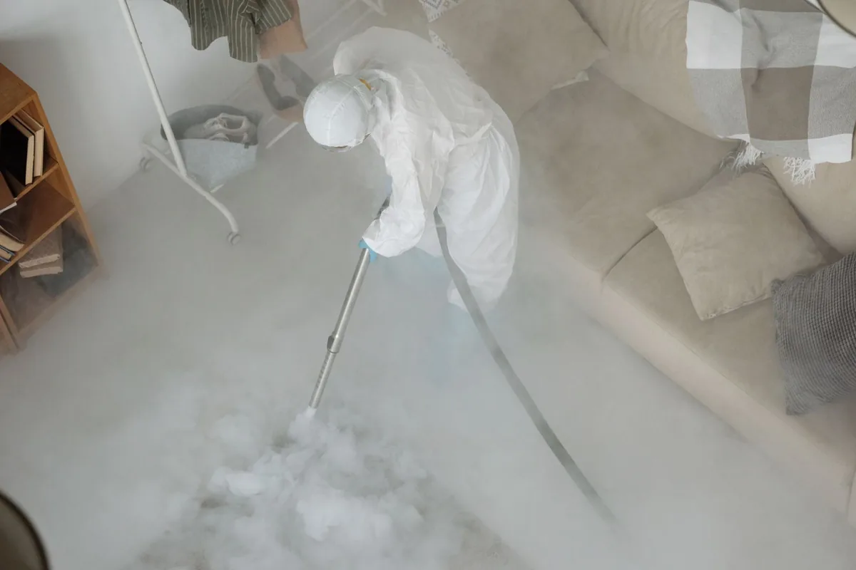 Biohazard cleanup technician in protective equipment, South River, NM